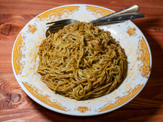 A serving of mouthwatering spicy rendang-flavored fried noodle.