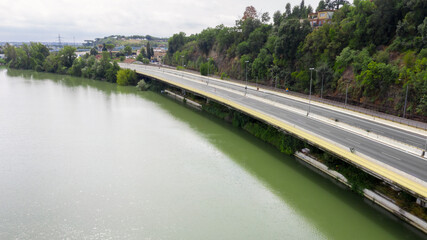 Aerial view of a bridge on the Via Tiberina in Rome, Italy. The road runs along the Tiber River.