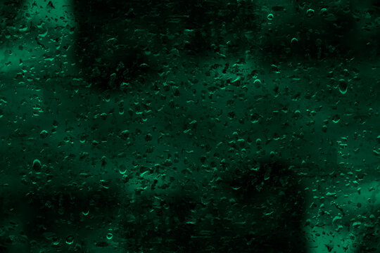 Water Drops On A Dark Green Blur Glass Surface For Background