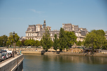 Fototapeta na wymiar Paris, France. August 2022. The picturesque embankments of the Seine in Paris, France. Buildings and trees.