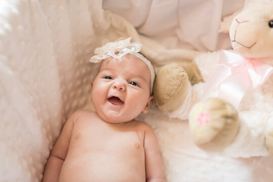 Little baby laughing in cot