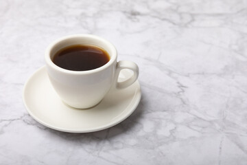 Fragrant coffee in a cup on a marble background.Espresso. Morning drink. Cheerful morning concept. Place for text. Place to copy.