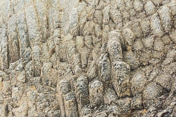 natural background, rock texture from weathered columnar basalt