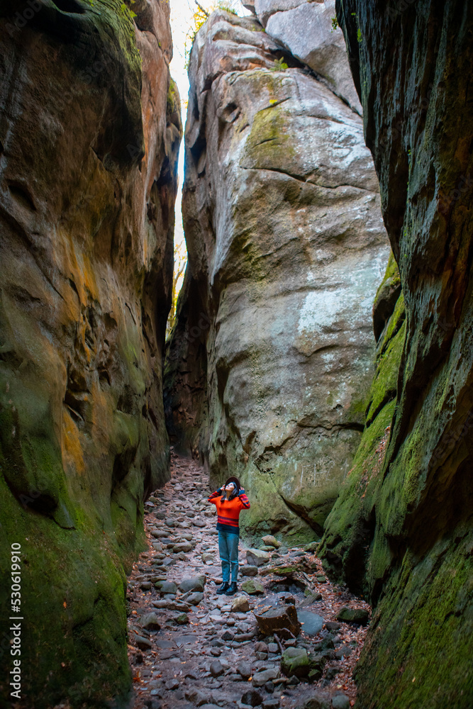 Poster woman traveler walking by trail in canyon