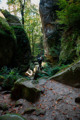 man hiker with backpack in canyon with forest