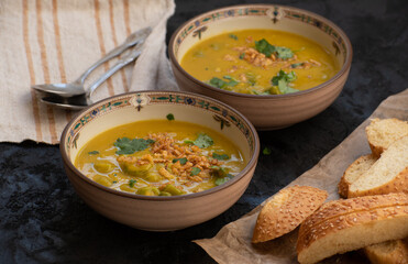 Vegan pumpkin and okra soup topped with crispy onions