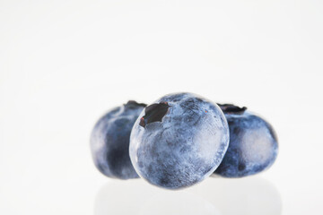 Blueberries on a white background. Close-up. Minimalism. There are no people in the photo. Tasty healthy product, juices, jams, stuffing for confectionery.