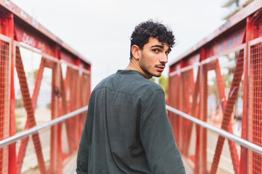 Hispanic man walking on bridge