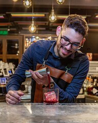 Latin Barman preparing alcoholic cocktail 