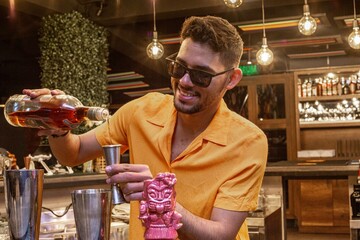 Latin Barman preparing alcoholic cocktail 