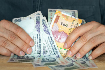 Indian rupees, File of banknotes held in the hand, Concept of financial success, winning or a hit financial investment