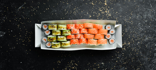 Japanese food. Set of sushi rolls with caviar, fish and shrimp. Food delivery. Free space for text.