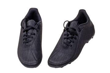 Closeup of a pair of black leather football boots isolated on white background. Professional athletics boys outdoor training shoes. Sports shoes.