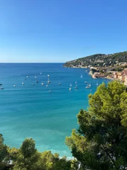 Papier Peint photo Villefranche-sur-Mer, Côte d’Azur View of Port Villefranche-Santé with boats, catamarans, sails boats, speed boats, and yachts moored to the pier, during daytime with a clear blue sky, Villefranche-sur-Mer, France.