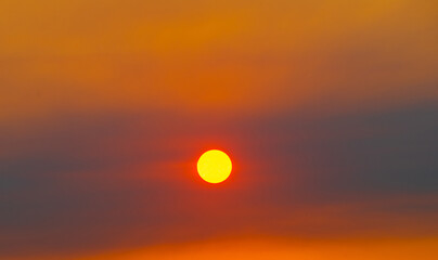 Obraz premium Clouds and sun in the yellow sky. Beautiful summer sunset