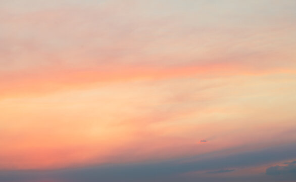 Pink clouds in the sky. Beautiful summer sunset background