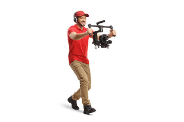 Full length shot of a camera operator walking and using a camera stabilizer