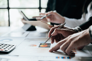 Close up of hands are working and brainstorming calculate on paperworks about business financial and marketing.
