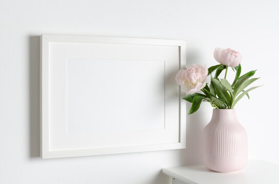 Landscape frame mockup on white wall with peony flowers, blank mockup with copy space for artwork