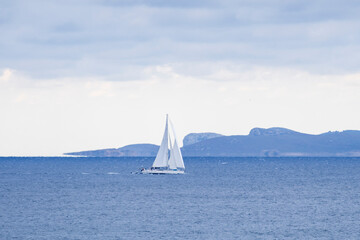 Obraz premium Sailing in front of the Cabrera Maritime National Park, Sa Rapita, Majorca, Balearic Islands, Spain