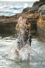 middle-aged woman dancing and throwing water in the air, Maioris beach, llucmajor, Majorca, Balearic Islands, Spain