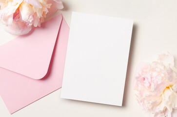 Wedding invitation card mockup with envelope and pink peony flowers