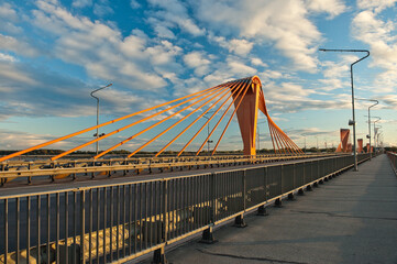 Fototapeta na wymiar cable-stayed bridge in Riga, in the photo south bridge in the evening against the background of blue sky and clouds