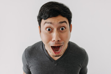 Funny surprised shocked asian man face for promotion isolated on background.