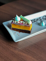 Close Up Rainbow Colorful Sweet Cake on Wooden Table