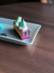 Close Up Rainbow Colorful Sweet Cake on Wooden Table