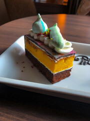 Close Up Rainbow Colorful Sweet Cake on Wooden Table