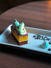 Close Up Rainbow Colorful Sweet Cake on Wooden Table