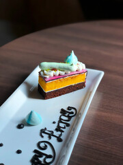 Close Up Rainbow Colorful Sweet Cake on Wooden Table