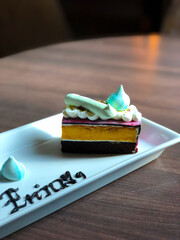 Close Up Rainbow Colorful Sweet Cake on Wooden Table