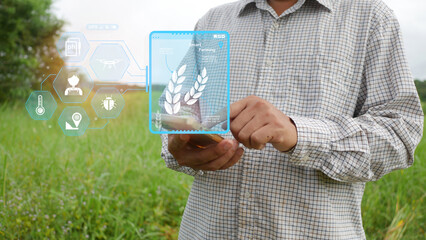 Farmers standing in green fields. Hologram showing agricultural technology icons.