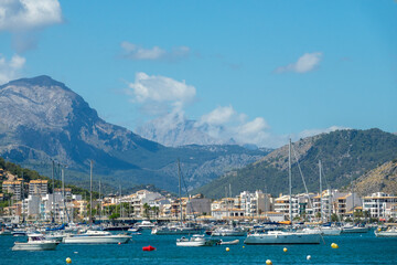 View of the port of Pollença (Spain) with the Puig Major in the background on a sunny summer morning