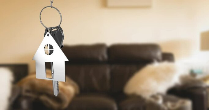 Animation of key with keychain in shape of house over living room interior