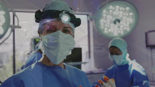 Animation of light spots over diverse surgeons wearing face masks