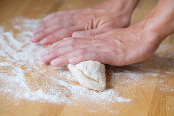 Person preparing dough for bread close-up