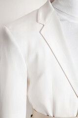 Close up of white blazer lapel. Fashion, elegance and styling.