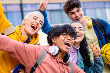 Group of multiethnic young friends having fun and smiling. Four diverse teen students enjoying the summer. Education concept. High quality photo