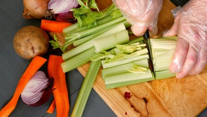 Chef chopping fresh vegetables ingredients prepared on chopping board 