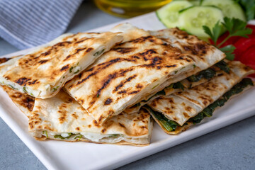 Traditional Turkish food, Turkish pancake gozleme with cheese and herb. The appetizer is Turkish pastry. There are varieties such as cheese, spinach, potato.
