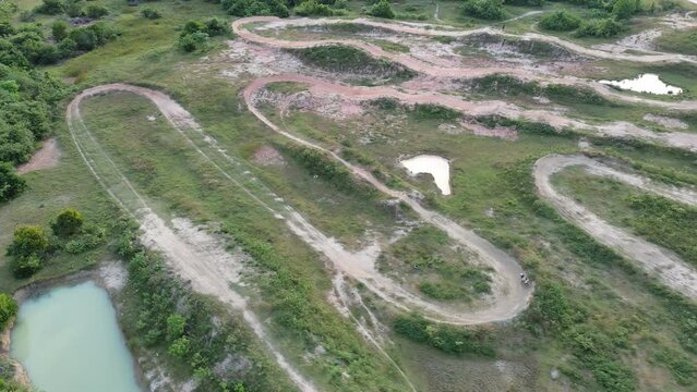Aerial view of motorcycle race track hills turns in countryside. Extreme desert motocross motorcycle ride in nature community, Championship competition and fun, Extreme sports active lifestyle racing 