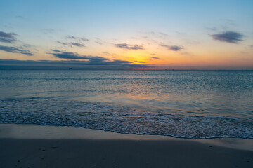 romantic view on sunset with sea water on the summer beach