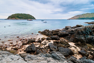 Fototapeta na wymiar Beautiful landscape with sea, rock, stones and cloudy sky.