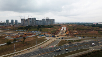 Construction site of a new city block. Construction of multi-storey buildings. Overcast weather. Aerial photography.