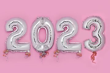 Balloon Bunting for celebration of New Year 2023 made from Silver Number Balloons. Holiday Party...