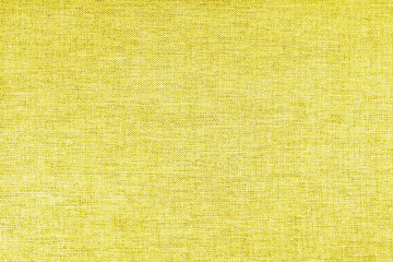 Texture of natural upholstery fabric or cloth. Fabric texture of natural cotton or linen textile material. Yellow canvas background. Decorative fabric for curtain, furniture, walls, clothes