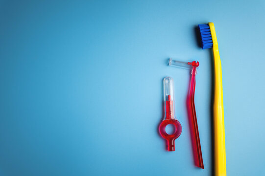 Dental hygiene. Toothbrush, hygienic brushes on a blue background. flat top view